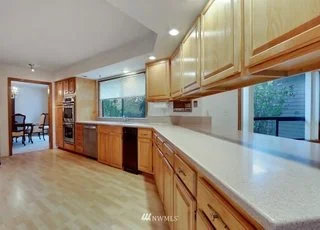 Kitchen with very long counter with well lit work areas and windows at 1300 28th Avenue Court, Milton, WA 98354