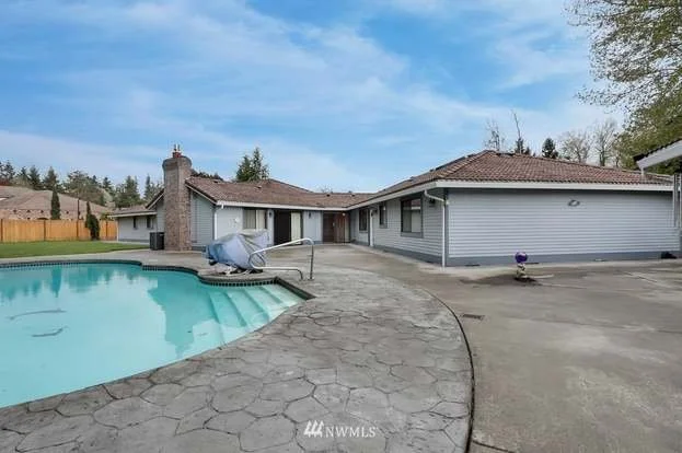 In ground pool with lift and patio area at 1300 28th Avenue Court, Milton, WA 98354
