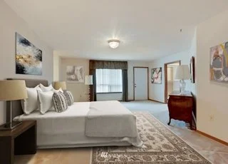 Spacious bedroom with low pile carpeting and ensuite bathroom and windows at 1300 28th Avenue Court, Milton, WA 98354