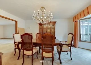 Formal dining room with tiled flooring, windows and large chandelier at 1300 28th Avenue Court, Milton, WA 98354 