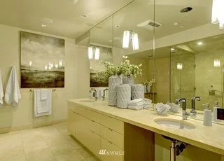 Bathroom with lower cabinets and roll under sink with counter to ceiling mirrors at 715 2nd Ave #1703 Seattle WA 98104