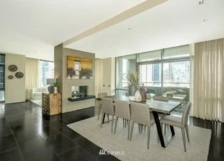 Dining room with floor to ceiling windows and granite floors at 715 2nd Ave #1703 Seattle WA 98104