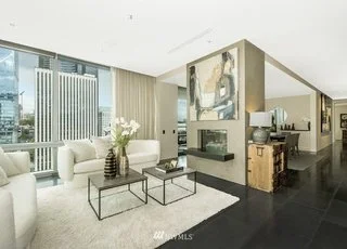 Living room with floor to ceiling windows and fireplace at 715 2nd Ave #1703 Seattle WA 98104