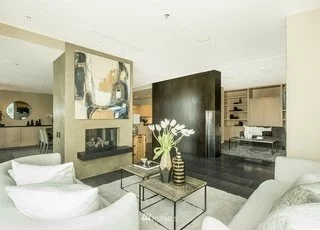 Living room with fireplace and art wall at 715 2nd Ave #1703 Seattle WA 98104