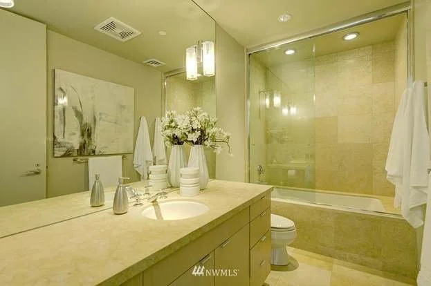 Bathroom with lower cabinets under sink and tub/shower combo at 715 2nd Ave #1703 Seattle WA 98104