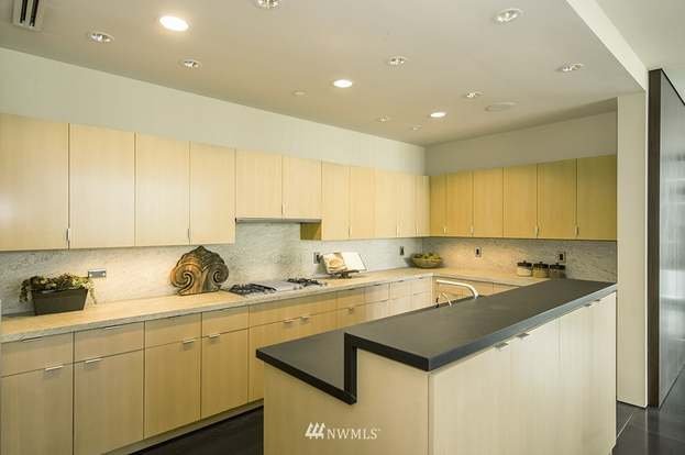 Kitchen with two tiered island and wrap around upper and lower cabinets at 715 2nd Ave #1703 Seattle WA 98104