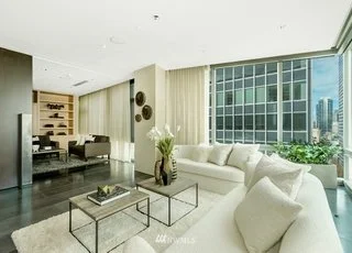 Living room with wrap around corner window and granite floors at 715 2nd Ave #1703 Seattle WA 98104
