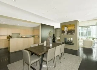 Dining area outside of kitchen with fireplace and art wall at 715 2nd Ave #1703 Seattle WA 98104