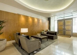 Foyer sitting area and double front doors in building lobby at 715 2nd Ave Seattle WA 98104