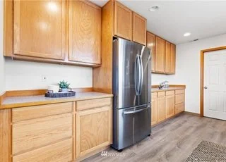 Kitchen with stainless steel fridge, cupboards and counters at 12112 Roosevelt Rd, Snohomish, WA 98290
