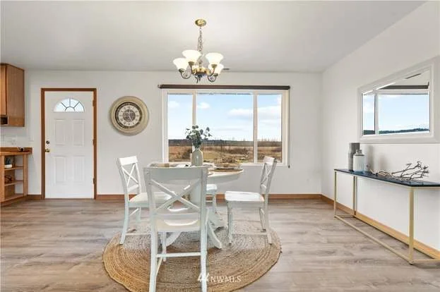 Dining room with large windows at 12112 Roosevelt Rd, Snohomish, WA 98290