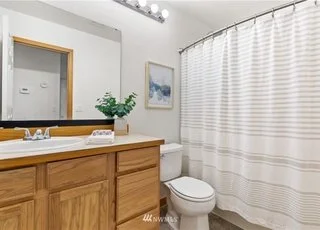 Bathroom with cabinets under sink counter and tub/shower combination at 12112 Roosevelt Rd, Snohomish, WA 98290