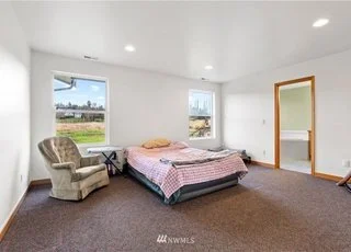 Large bedroom with two large windows at 12112 Roosevelt Rd, Snohomish, WA 98290