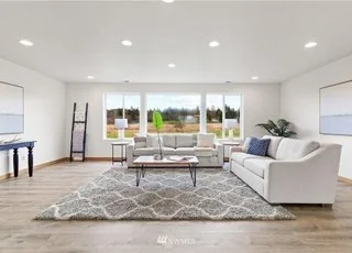 Livingroom with couch, table and expansive windows at 12112 Roosevelt Rd, Snohomish, WA 98290