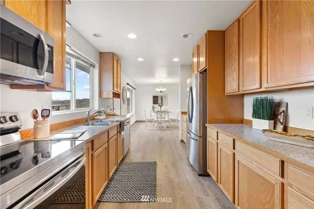 Kitchen with stove, upper and lower cupboards at 12112 Roosevelt Rd, Snohomish, WA 98290