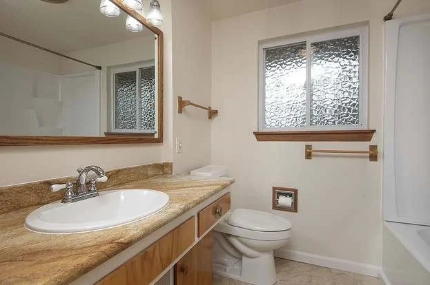 Bathroom with roll under sink, high mirror and bathtub at 19607 Heinz Pl, Lynnwood, WA 98036