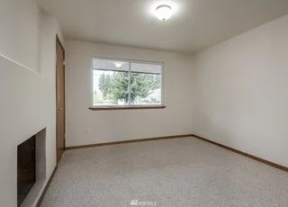 Bedroom with window, low pile carpeting and recessed fireplace at 19607 Heinz Pl,
Lynnwood, WA 98036