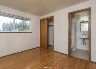Bedroom with window, closet and entry into bathroom at 19607 Heinz Pl, Lynnwood, WA 98036