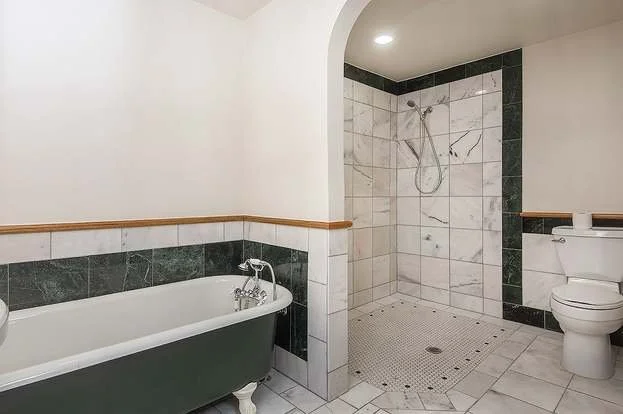 Bathroom with tiled flooring, claw foot tub and roll in shower at 19607 Heinz Pl, Lynnwood, WA 98036