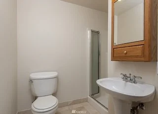 Bathroom with roll under sink, high vanity/mirror and tiled flooring at 19607 Heinz Pl, Lynnwood, WA 98036