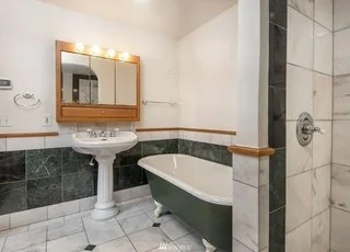 Bathroom with roll under sink, clawed bathtub and tiled shower at 19607 Heinz Pl,
Lynnwood, WA 98036