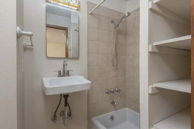 Bathroom with roll under sink, bathtub and linen closet at 19607 Heinz Pl, Lynnwood, WA 98036