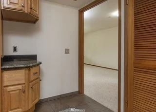 Utility room with tiled flooring and storage at 19607 Heinz Pl, Lynnwood, WA 98036