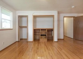 Office area with window, closet with shelving and built in desk and file cabinet at 19607 Heinz Pl, Lynnwood, WA 98036