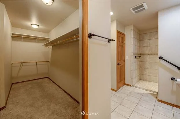Walk in closet with built in upper and lower rods next to bathroom at 104 Quail Lane Cashmere WA 98815