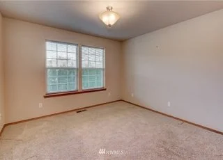 Bedroom with double window and carpeting at 104 Quail Lane Cashmere WA 98815