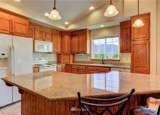 Kitchen with large island and hanging lights at 104 Quail Lane, Cashmere WA 98815