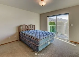Bedroom with sliding doors leading to deck at 104 Quail Land Cashmere WA 98815