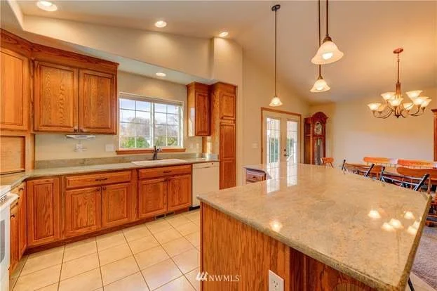 Kitchen with wrap around island and hanging lights at 104 Quail Lane Cashmere WA 98815
