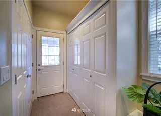Back entrance hallway with built in closets on both sides at 2125 118th Ave E Edgewood WA 98372