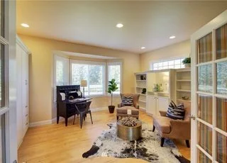 Den area with recessed lighting, hardwood floors and built in bookshelves and storage at 2125 118th Ave E Edgewood WA 98372