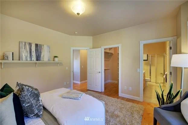 Bedroom with shelf, hardwood floors, walk in closet and attached bathroom at 2125 118th Ave E Edgewood WA 98372