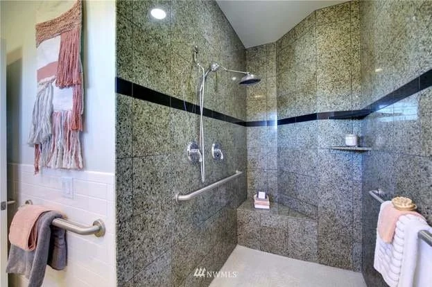 Bathroom with roll in shower, tiled walls with grab bars at 2125 118th Ave E Edgewood WA 98372