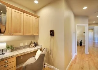 Desk alcove with granite work area, upper cabinets and drawers at 2125 118th Ave E Edgewood WA 98372