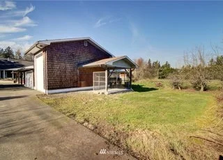 Driveway leading to garage and covered parking at 2125 118th Ave E Edgewood WA 98372