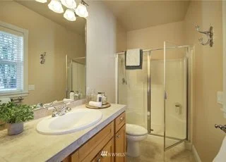 Bathroom with sink, lower cabinets and walk in shower at 2125 118th Ave E Edgewood WA 98372