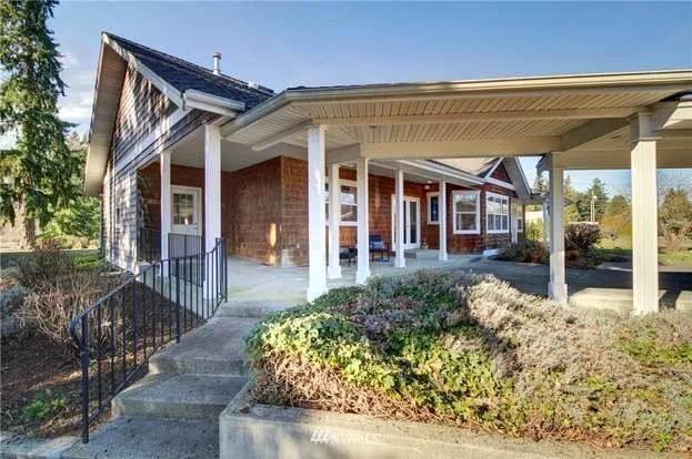 Stairs from drive way leading to undercover parking and patio area at 2125 118th Ave E Edgewood WA 98372