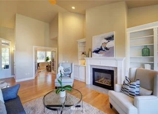 Open concept living room area with fireplace and built in bookcases at 2125 188th Ave E Edgewood WA 98372