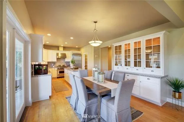 Dining area with built in buffet, hardwood floors and chandelier at 2125 118th Ave E Edgewood WA 98372