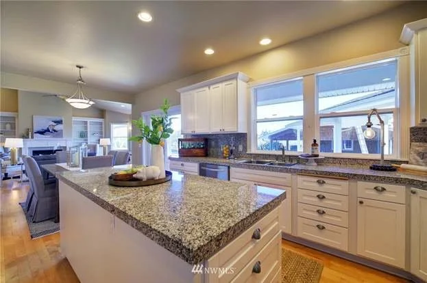 Kitchen with island with drawers, sink with lower cabinets and drawers at 2125 118th Ave E Edgewood WA 98372
