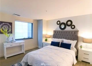 Bedroom with window and receding bed headboard wall at 820 Blanchard St #810 Seattle 98121