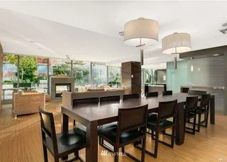 Open concept dining area with double chandeliers at 820 Blanchard St #810 Seattle WA 98121