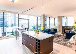 Kitchen with functional island and floor to ceiling windows at 820 Blanchard St #810 Seattle 98121