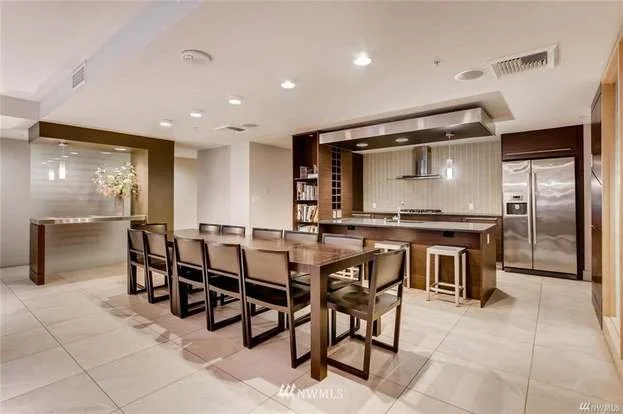 Dining area and kitchen with island seating at 820 Blanchard St #810 Seattle WA 98121