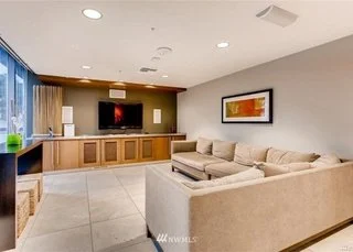 Living room with media wall built ins and tiled flooring at 820 Blanchard St #810 Seattle WA 98121