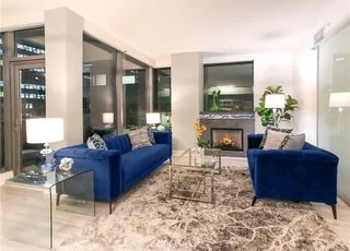 Living room with fireplace and floor to ceiling windows at 820 Blanchard St #810 Seattle WA 98121
